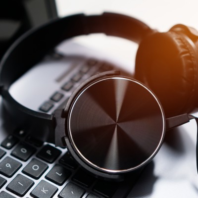Headset or headphone on laptop keyboard for helpline customer on communication and hotline support call center service. voip digital phone for helpdesk in business office